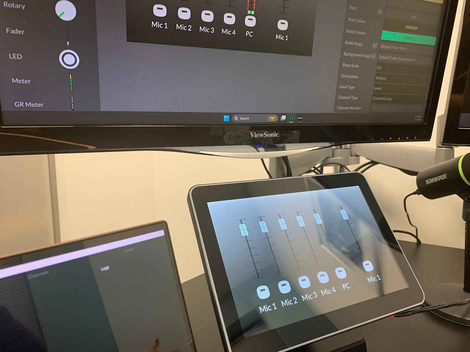 Touchscreen audio mixer interface displaying microphone and PC channel levels